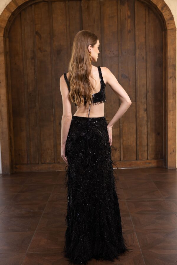 The back view of a woman in an Alinia feathered gown.