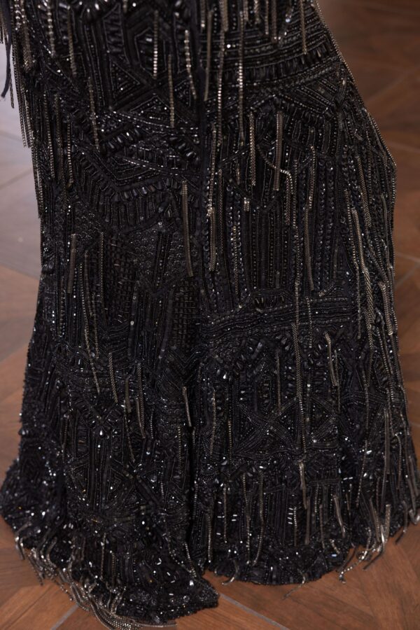 The back of a woman's Victoria dress with fringes on it.