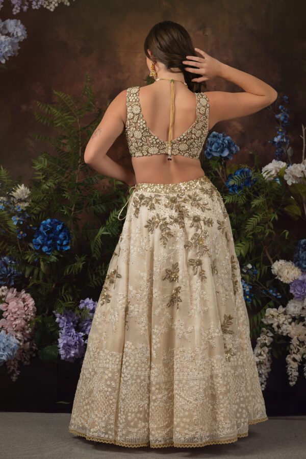 The back view of a woman wearing a PERLA embroidered lehenga.