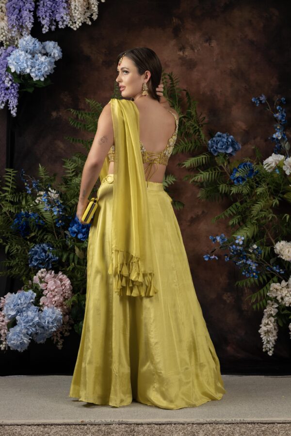 The back view of a woman in a yellow Miraya.