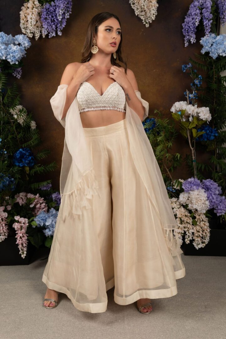 The model is wearing an Ivory Pant Lehengha set and a white blouse.
